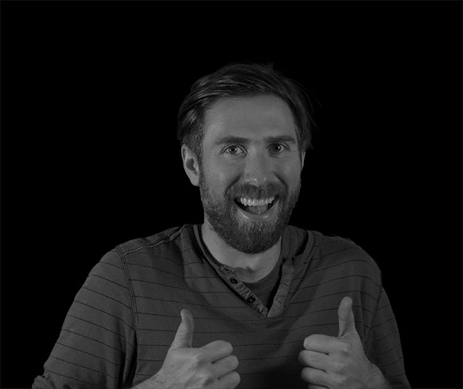 profile picture of bearded man, smiling with two thumbs up